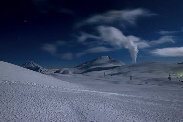 Steam rises on a moonlit nightfrom a geothermal power plant in the Kamchatka mountains, near the Mutnovsky volcano.