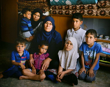 Samira Leylan, 50, with family at her home in Bashir village. Bashir was retaken from ISIS in May 2016 and and since then its residents have begun returning home. The frontline with ISIS is still very...