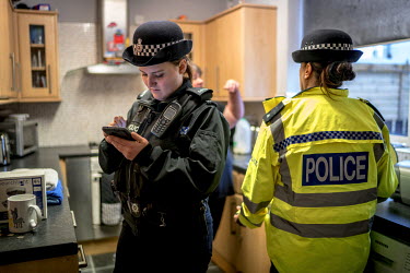 PC Francesca Wheatley (left) interviews a man who complained of someone ransacking the family's recycling bin. Police believe the man stashed something there during a police action the previous night.