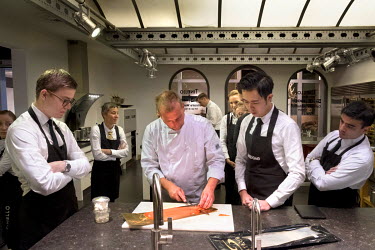 Tinello's Master Chef Mr. Riny van den Oord shows a group of student butlers the correct way to slice smoked salmon. One of the many items on the curriculum during the intensive, eight-week butler's t...
