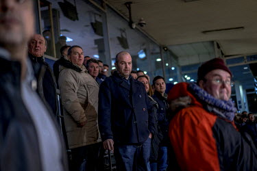 People watch the races from the stands at Romford's Greyhound Racing Stadium.