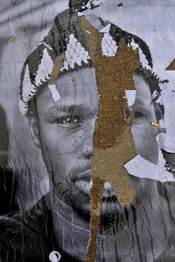 A portrait of a refugee seeking asylum in Switzerland, defaced during an exhibition and thus likely showing the hand of prejudice and rejection. The original series was produced as part of an anti rac...