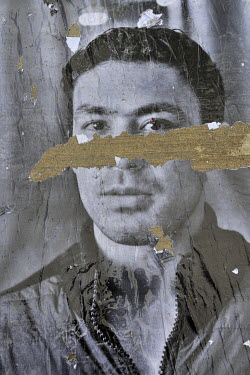 A portrait of a refugee seeking asylum in Switzerland, defaced during an exhibition and thus likely showing the hand of prejudice and rejection. The original series was produced as part of an anti rac...