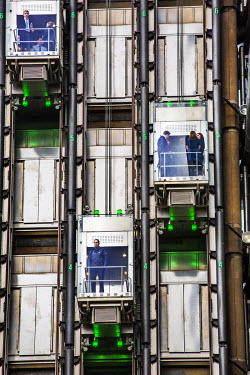 Office staff ride lifts that run up on the outside of a building in the City of London.