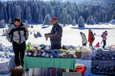 Former refugee Elvis Causevic (left) with his father Nedzib who collects and sells herbal teas (Planinski Caj - Mountain Tea) and tonics from a stall on the Igman plateau, one of the venues for the 19...