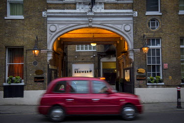 A taxi passes The Brewery in the City of London.