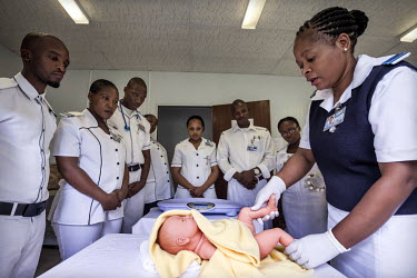 Students at the Roma School of Nursing during practical training in the skills lab using a simulation babty mannequin.