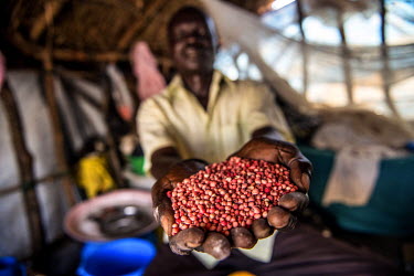 Joseph Malis, 39, in Bidibidi refugee camp with seeds donated by an aid agency. Malis fled his home in Gimono village, South Sudan, after government soldiers burned it down killing three people in Aug...