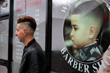 Havar, 17, with his new haircut at Wiry's Barber shop in the city centre.