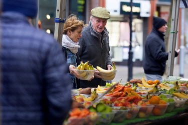 People shopping in the fruit and vegetable market in the city centre.
