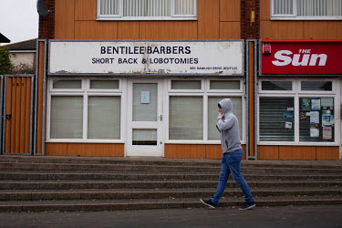 A barber with a signboard offering 'Short Back & Lobotomies' on the Bentilee estate.