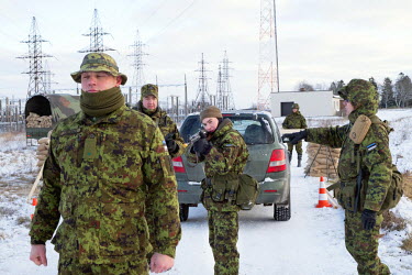 Kaitseliit ('Defence League', a paramilitary force made up of civilian volunteers but instructed and commanded by military officers) volunteers practise how to stop and search people at a checkpoint g...