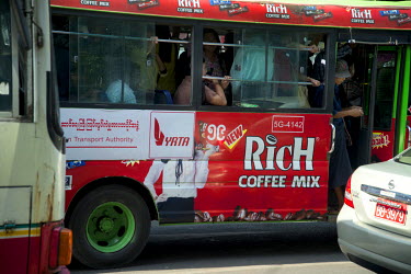 An advertisement for 'Rich Coffee Mix' on the side of a city bus.