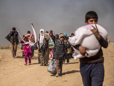 Civilians wave white flags as they flee the fighting in west Mosul towards the Iraqi army's front line. In February 2017 Iraqi troops launched a long awaited operation to liberate west Mosul, which ha...