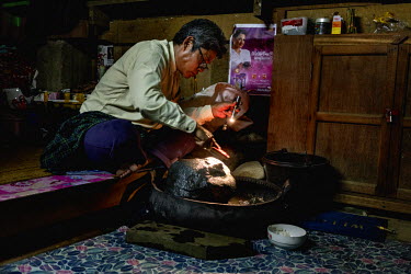 A jade trader cleans a rough jade rock in his home.