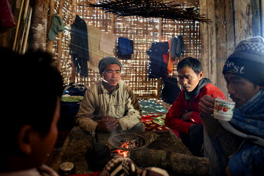 Hkawng Lum, 35, (2nd from right) a freelance jade miner and heroin addict, who worked in the mines for 10 years, warms himself by the fire with other drug addicts at Wauk Wain Drug Rehabilitation faci...