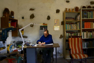 Eloino Perdomo Placeres working in his office at his home where he has grown over 2,000 varieties of cacti. He donated plants to help artist and enviromentalist Cesar Manrique to build his own cactus...