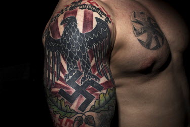 A member of the PPDM (Straight Edge Father Frost Mode) with WW2 nazi tattoos. The group promotes a healthy lifestyle. No smoking, no drinking and fight against modern decadence. Their gym-trained bodi...
