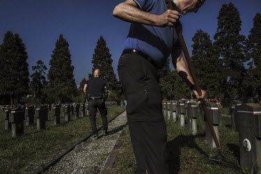 Members of the fascist Lealta e Azione group visiting a cemetery in Milan where many Italian fascists are buried. Lealta e Azione members help look after the site. 'Nobody else cares about these grave...