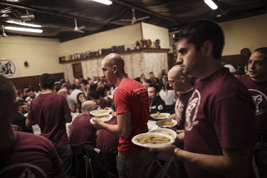 Members of the fascist Lealta e Azione group gather for a meal at the 'Skinhouse', the meeting place for the group.