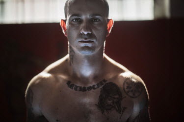 Luca, a member of the fascist Lealta e Azione group, trains in a boxing studio.
