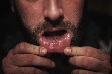 Self-proclaimed neo-nazi Evgenij Stojka shows off a swastika tattooed on the inside of his lip 'I got interested in the nazi movement and Adolf Hitler when I was 14 years old. I joined the skinheads,...