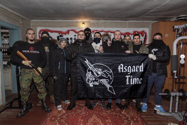 Members of the National Socialist group KNS (Committee for Nation and Freedom) with weapons and a banner at their clubhouse in a Moscow suburb.   'We train with weapons and practice skills in the fiel...