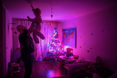 Self-proclaimed neo-nazi Evgenij Stojka plays with his daughter in the family home. 'I got interested in the nazi movement and Adolf Hitler when I was 14 years old. I joined the skinheads, and later b...