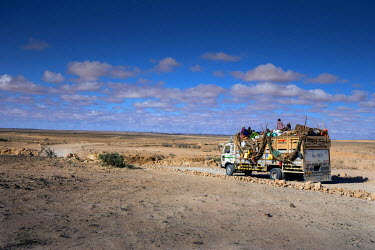A group of nomadic pastoralists resettling in the Garadag district after a 60km journey on a truck with their animals.  The vehicle is carrying nine families and what is left of their herds, some shee...