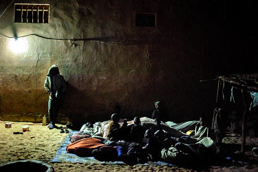 Night time in marabout Cheikh Amadou Bamba's Daara (religious school). The children crowd together to sleep under a piece of fabric. It is January and it is cold in Saint Louis. There are about 50 Tal...