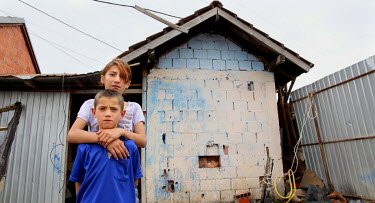 Two children from the Ashkali (Albanian-speaking Roma) community outside their home, in Fushe Kosovo (Kosovo Polje), one of the poorest suburbs of Pristina, where they live with two other siblings and...