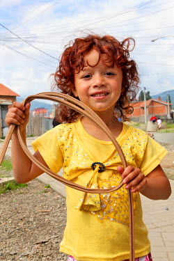 A Roma child plays in the streets of Mitrovica South, one of the poorest suburbs of the city.