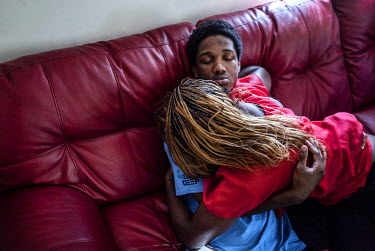 Claressa Shields, 20, arm-in-arm with her boyfriend Adrell Holmes on the couch moments after an unknown gunman fired six shots into their family's home. The next day Shields moved out of Flint for the...