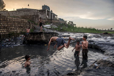 Boys play in the natural hot springs in Hamam al Alil, which was recaptured from ISIS militants at the end of 2016.