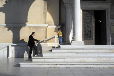A Roma boy begs in front of the Apostotolos Andreas church.