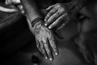Mike, a resident of Slab City, a squatters' camp about 190 miles southeast of Los Angeles, reveals his tattooed hands. Each design represents different phases of his growth.   Slab City, known as Th...