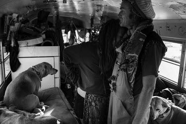 A couple with their dog in an old school bus which they have turned into their home in Slab City, a squatters' camp about 190 miles southeast of Los Angeles.   Slab City, known as The Slabs, is named...