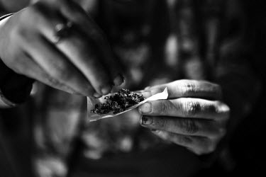 39 year old Connie rolling a joint. She says she was sexually assaulted by adults as a child and has been living in Slab City, a squatters' camp about 190 miles southeast of Los Angeles, for almost tw...