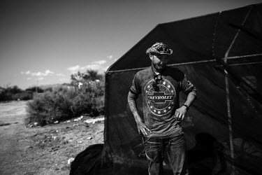 John, 27, from Louisiana where he was born and raised beside his tented home in Slab City, a squatters' camp about 190 miles southeast of Los Angeles. A veteran, John served in Afghanistan for two yea...