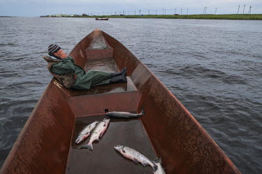 Fisherman Sergey Smiyan (27) on a boat near Oktyabrsky. He believes the storms in the area have increased over the last years, causing notable changes in the migration routes of the fish population.