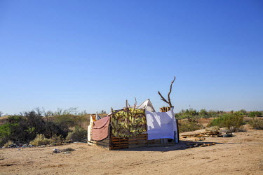 A home made of branches, fabric, and panel boards in Slab City, a squatters' camp about 190 miles southeast of Los Angeles.  Slab City, known as The Slabs, is named for its areas of concrete where for...