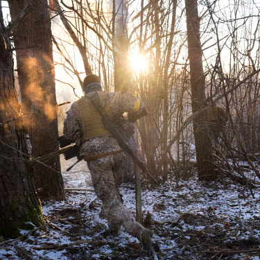 A member of the Latvian Zemessardze ('National Guard') runs through the forest during a joint exercise with the Estonian Kaitseliit ('Defence League'), both civilian volunteer militias. During the tra...
