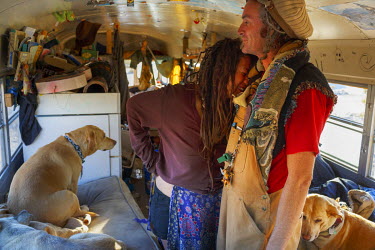 A couple with their dog in an old school bus which they have turned into their home in Slab City, a squatters' camp about 190 miles southeast of Los Angeles.   Slab City, known as The Slabs, is named...