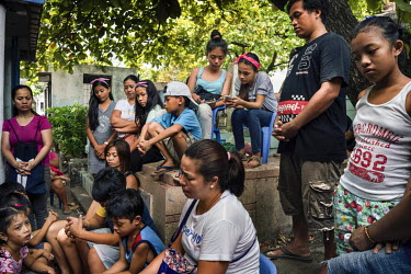 The extended family of people who died two years ago gather to pray after having a picnic by their tomb on Easter Sunday at Manila North Cemetery. Manila North Cemetery is home to thousands of 'inform...