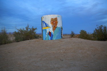 A portrait of Leonard Knight, creator of Salvation Mountain, on a water tank near Slab City, a squatters' camp about 190 miles southeast of Los Angeles.  Slab City, known as The Slabs, is named for it...