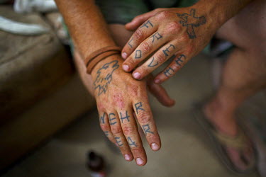 Mike, a resident of Slab City, a squatters' camp about 190 miles southeast of Los Angeles, reveals his tattooed hands. Each design represents different phases of his growth.   Slab City, known as Th...
