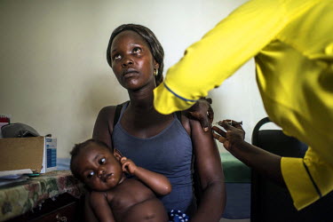 A sex worker receives an immunization at the RHU (Reproductive Health Uganda) clinic.