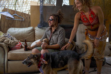 Mike and Lily with their dogs in Slab CIty, a squatters' camp about 190 miles southeast of Los Angeles, where they have been living since late 2015.  Slab City, known as The Slabs, is named for its ar...