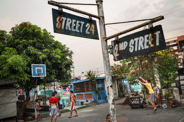 Residents play basketball at Manila North Cemetery.  Manila North Cemetery is home to thousands of 'informal settlers' who have built shacks using in and around the mausoleums, crypts and tombs. In co...