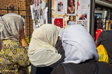Local Muslim residents looking at photos missing people following the devastating fire that swept up the 24 storey Grenfell Tower in North Kensington In the early hours of Wednesday, 14th June killing...